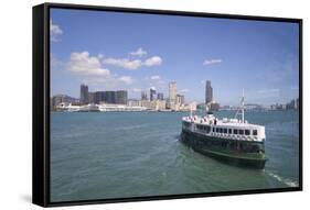 Star Ferry sailing towards the Kowloon side of Victoria Harbour, Hong Kong, China, Asia-Fraser Hall-Framed Stretched Canvas