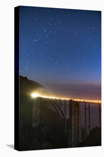 Stars over Big Sur's Bixby Creek Bridge near Monterey, California at night along the coast-David Chang-Stretched Canvas