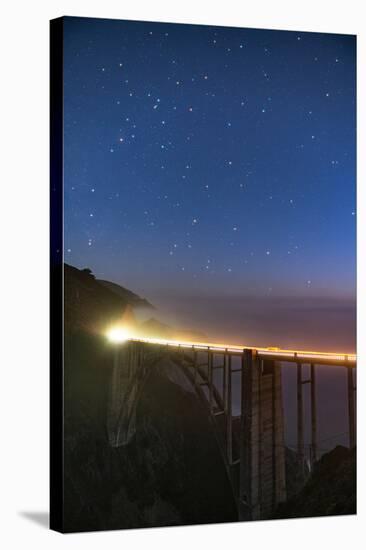Stars over Big Sur's Bixby Creek Bridge near Monterey, California at night along the coast-David Chang-Stretched Canvas