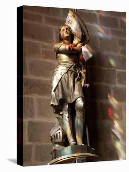 Statue of St. Joan of Arc with Coloured Light from Stained Glass, Church of Notre Dame, Vitre, Brit-Nick Servian-Stretched Canvas