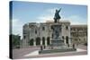 Statue on a Pedestal in Front of a Cathedral-null-Stretched Canvas