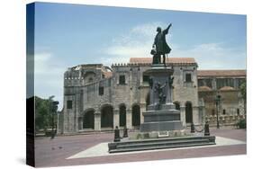 Statue on a Pedestal in Front of a Cathedral-null-Stretched Canvas