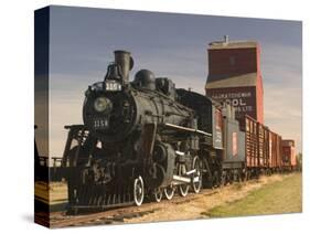 Steam Train and Grain Elevator in Western Development Museum, Saskatchewan, Canada-Walter Bibikow-Stretched Canvas