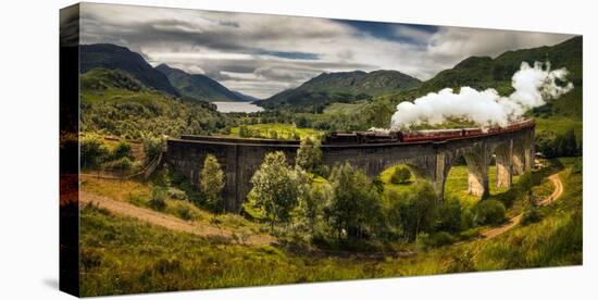 Steam train moving on old bridge, Scotland-null-Stretched Canvas