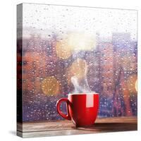 Steaming Cup of Coffee over a Cityscape Background-George D.-Stretched Canvas