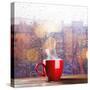 Steaming Cup of Coffee over a Cityscape Background-George D.-Stretched Canvas