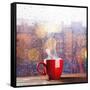 Steaming Cup of Coffee over a Cityscape Background-George D.-Framed Stretched Canvas