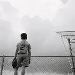 View from Behind of a Girl Holding a Soccer Ball-Steve Cicero-Laminated Photographic Print