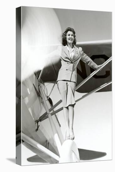 Stewardess Balancing on Plane Wheel-null-Stretched Canvas