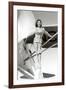 Stewardess Balancing on Plane Wheel-null-Framed Art Print