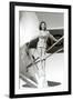 Stewardess Balancing on Plane Wheel-null-Framed Art Print