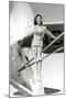 Stewardess Balancing on Plane Wheel-null-Mounted Art Print