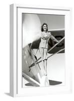 Stewardess Balancing on Plane Wheel-null-Framed Art Print