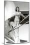 Stewardess Balancing on Plane Wheel-null-Mounted Art Print