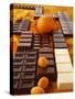 Still Life of Chocolate Bars and Citrus Fruit-Luzia Ellert-Stretched Canvas