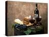 Still Life of Wine Bottle, Wine Glasses, Cheese and Purple Grapes on Top of Barrel-null-Stretched Canvas