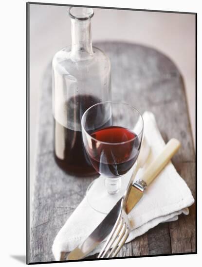 Still Life with Red Wine Glass, Wine Carafe, Napkin and Cutlery-Jean Cazals-Mounted Photographic Print