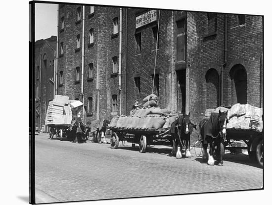 Stock Is Unloaded from Horse- Pulled Wagons and Drawn Up into the Warehouse by Rope-null-Stretched Canvas