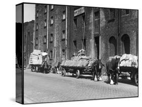 Stock Is Unloaded from Horse- Pulled Wagons and Drawn Up into the Warehouse by Rope-null-Stretched Canvas