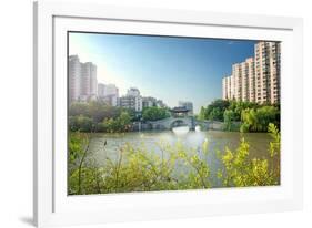 Stone bridge with pagoda style roofing, flanked by old style apartment buildings on the left and ne-Andreas Brandl-Framed Photographic Print