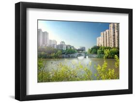 Stone bridge with pagoda style roofing, flanked by old style apartment buildings on the left and ne-Andreas Brandl-Framed Photographic Print