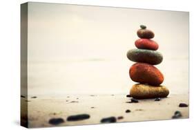 Stones Pyramid on Sand Symbolizing Zen, Harmony, Balance. Ocean in the Background-Michal Bednarek-Stretched Canvas