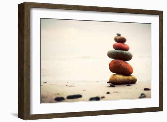 Stones Pyramid on Sand Symbolizing Zen, Harmony, Balance. Ocean in the Background-Michal Bednarek-Framed Photographic Print