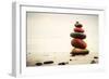 Stones Pyramid on Sand Symbolizing Zen, Harmony, Balance. Ocean in the Background-Michal Bednarek-Framed Photographic Print