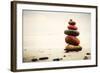 Stones Pyramid on Sand Symbolizing Zen, Harmony, Balance. Ocean in the Background-Michal Bednarek-Framed Photographic Print