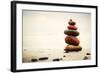 Stones Pyramid on Sand Symbolizing Zen, Harmony, Balance. Ocean in the Background-Michal Bednarek-Framed Photographic Print