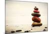 Stones Pyramid on Sand Symbolizing Zen, Harmony, Balance. Ocean in the Background-Michal Bednarek-Mounted Photographic Print