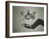 Stopwatch With Butterfly Wings Levitating Above Hand, Black And White, Slight Green Toning-foodbytes-Framed Art Print