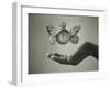 Stopwatch With Butterfly Wings Levitating Above Hand, Black And White, Slight Green Toning-foodbytes-Framed Art Print