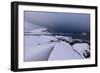 Storm clouds on the snowy peaks reflected in the cold sea at night, Haukland, Northern Norway-Roberto Moiola-Framed Photographic Print