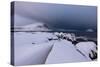 Storm clouds on the snowy peaks reflected in the cold sea at night, Haukland, Northern Norway-Roberto Moiola-Stretched Canvas