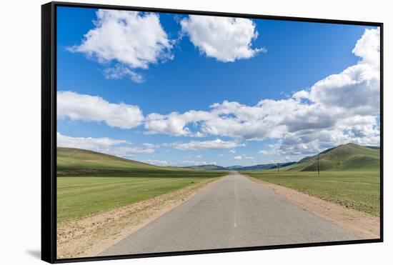 Straight road in the Mongolian steppe and clouds in the sky, North Hangay province, Mongolia, Centr-Francesco Vaninetti-Framed Stretched Canvas