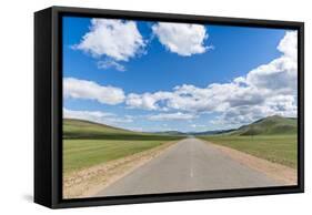 Straight road in the Mongolian steppe and clouds in the sky, North Hangay province, Mongolia, Centr-Francesco Vaninetti-Framed Stretched Canvas