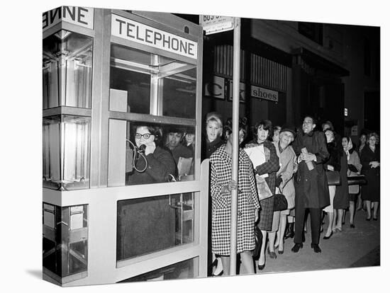 Stranded New York Workers Wait Patiently in a Long Line to Use a Phone Booth to Call Home-null-Stretched Canvas