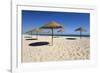 Straw umbrellas on empty white sand beach with clear sea behind, Ilha do Farol, Culatra Barrier Isl-Stuart Black-Framed Photographic Print