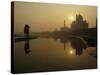 Stray Dog on a Sand Bank of the Yamuna River as the Sun is Seen Rising over the Taj Mahal in India-null-Stretched Canvas
