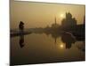 Stray Dog on a Sand Bank of the Yamuna River as the Sun is Seen Rising over the Taj Mahal in India-null-Mounted Photographic Print