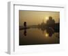 Stray Dog on a Sand Bank of the Yamuna River as the Sun is Seen Rising over the Taj Mahal in India-null-Framed Photographic Print