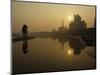 Stray Dog on a Sand Bank of the Yamuna River as the Sun is Seen Rising over the Taj Mahal in India-null-Mounted Photographic Print