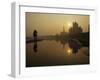 Stray Dog on a Sand Bank of the Yamuna River as the Sun is Seen Rising over the Taj Mahal in India-null-Framed Photographic Print