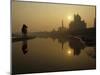 Stray Dog on a Sand Bank of the Yamuna River as the Sun is Seen Rising over the Taj Mahal in India-null-Mounted Photographic Print