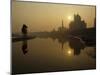 Stray Dog on a Sand Bank of the Yamuna River as the Sun is Seen Rising over the Taj Mahal in India-null-Mounted Photographic Print