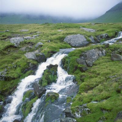 https://imgc.allpostersimages.com/img/posters/stream-rushing-over-rocks-in-a-wet-misty-environment-estoroy-island-faroe-islands-denmark_u-L-P6KU9M0.jpg?artPerspective=n
