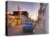 Street Scene at Twilight with Classic Blue American Car, Cienfuegos-Lee Frost-Stretched Canvas