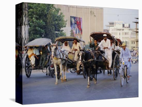 Street Scene with Horse Drawn Carriages, Rawalpindi, Punjab, Pakistan-David Poole-Stretched Canvas