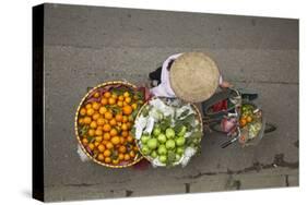 Street vendor with baskets of fruit on bicycle, Old Quarter, Hanoi, Vietnam-David Wall-Stretched Canvas